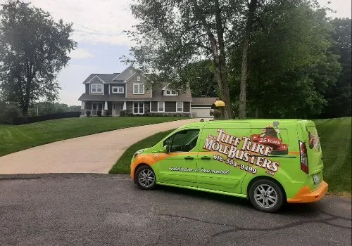 Tuff Turf Mole Busters vehicle parked in front of a home in Grand Rapids, MI