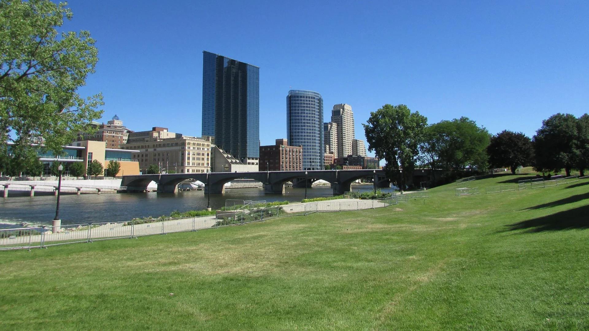 Downtown Grand Rapids with river and lawn.