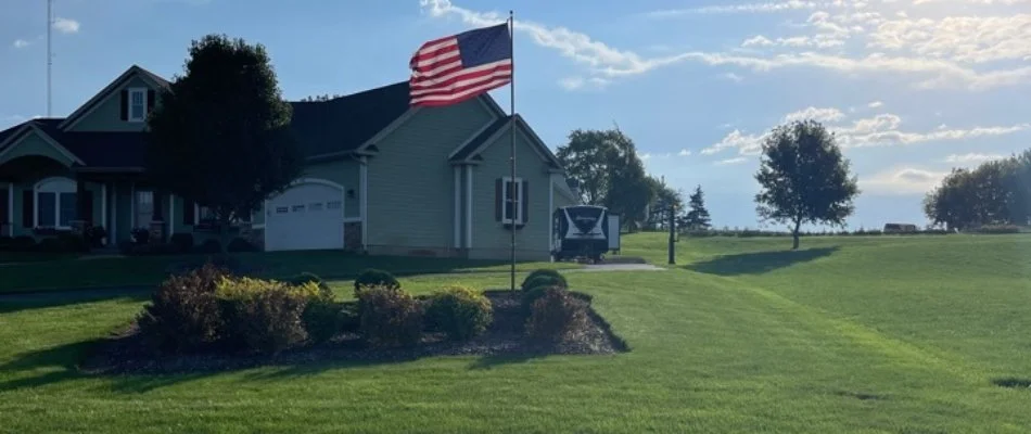 Lawn in Belding, MI, with American flag.
