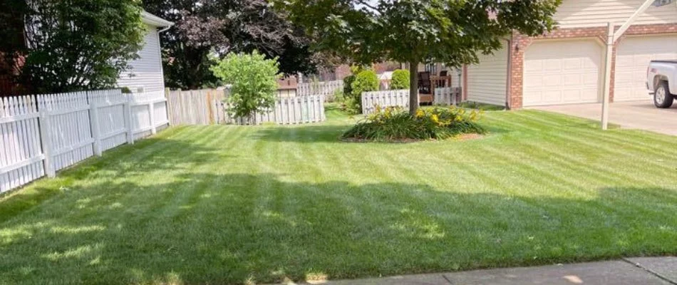 Lawn with white fence in Kalamazoo, MI.