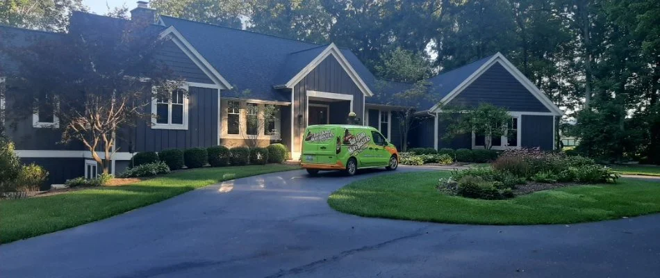 Lawn with green van in driveway in Hamilton, MI.