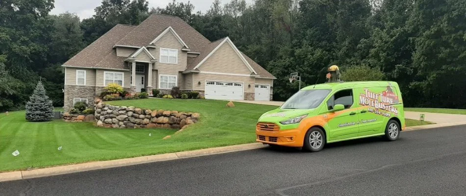 Tuff Turf van in front of a house in Byron Center, MI, with a lawn. 