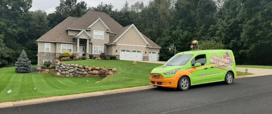 Green van in front of a home in Saranac, MI.