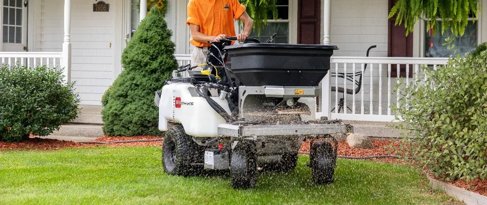 A worker in Allendale Charter Township, MI, on a fertilizer spreader.