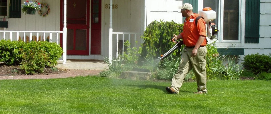 A worker using a fogger to treat a yard in Mattawan, MI, for mosquitoes.